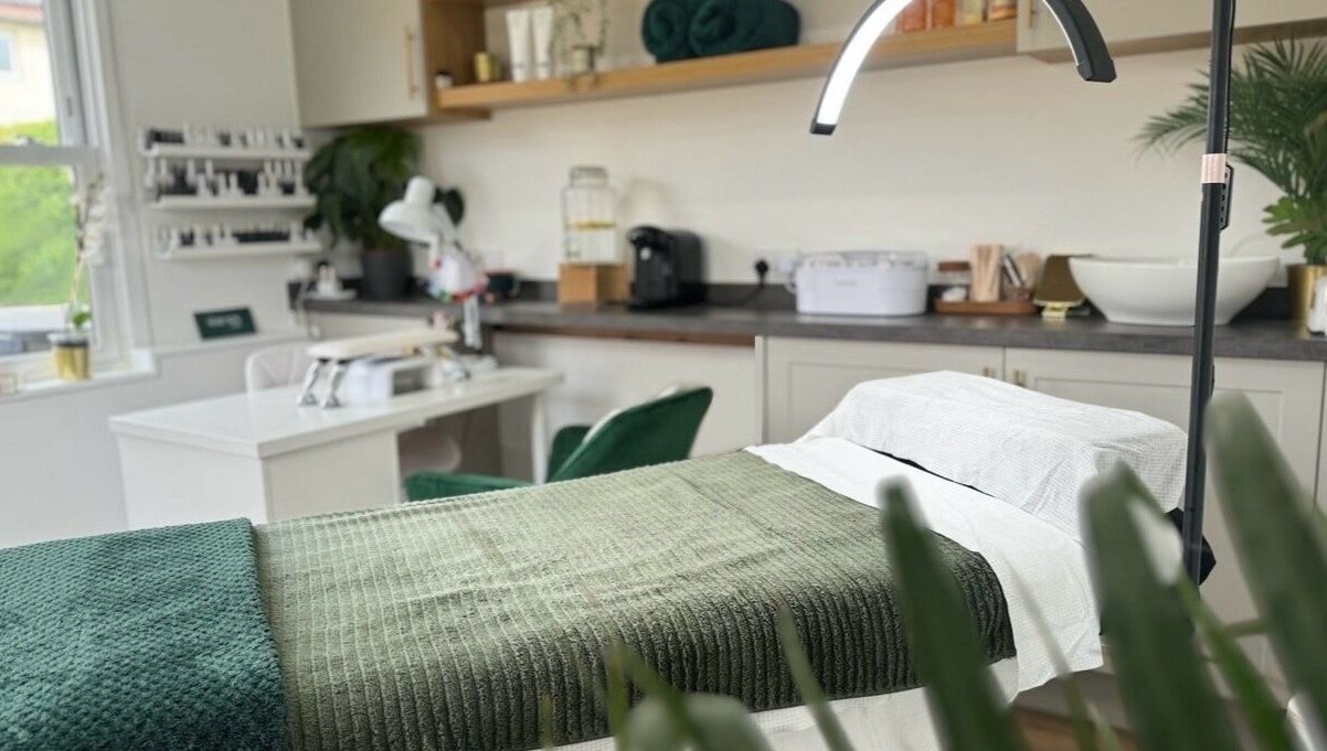 Luxurious treatment room at The Serenity Salon, Fareham, England, GB, featuring a cozy, green-themed decor.