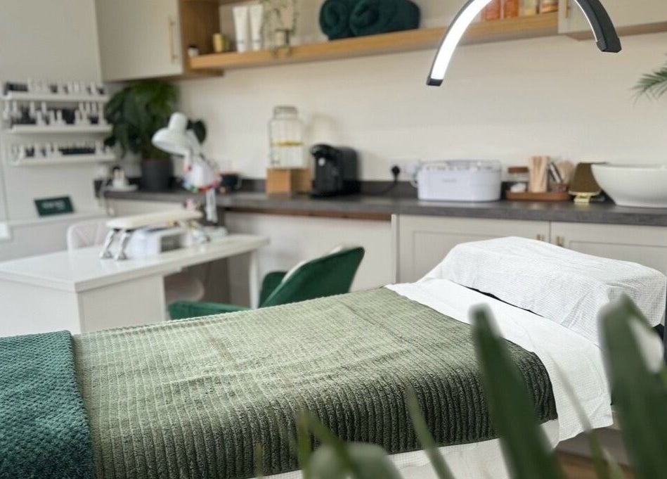 Luxurious treatment room at The Serenity Salon, Fareham, England, GB, featuring a cozy, green-themed decor.