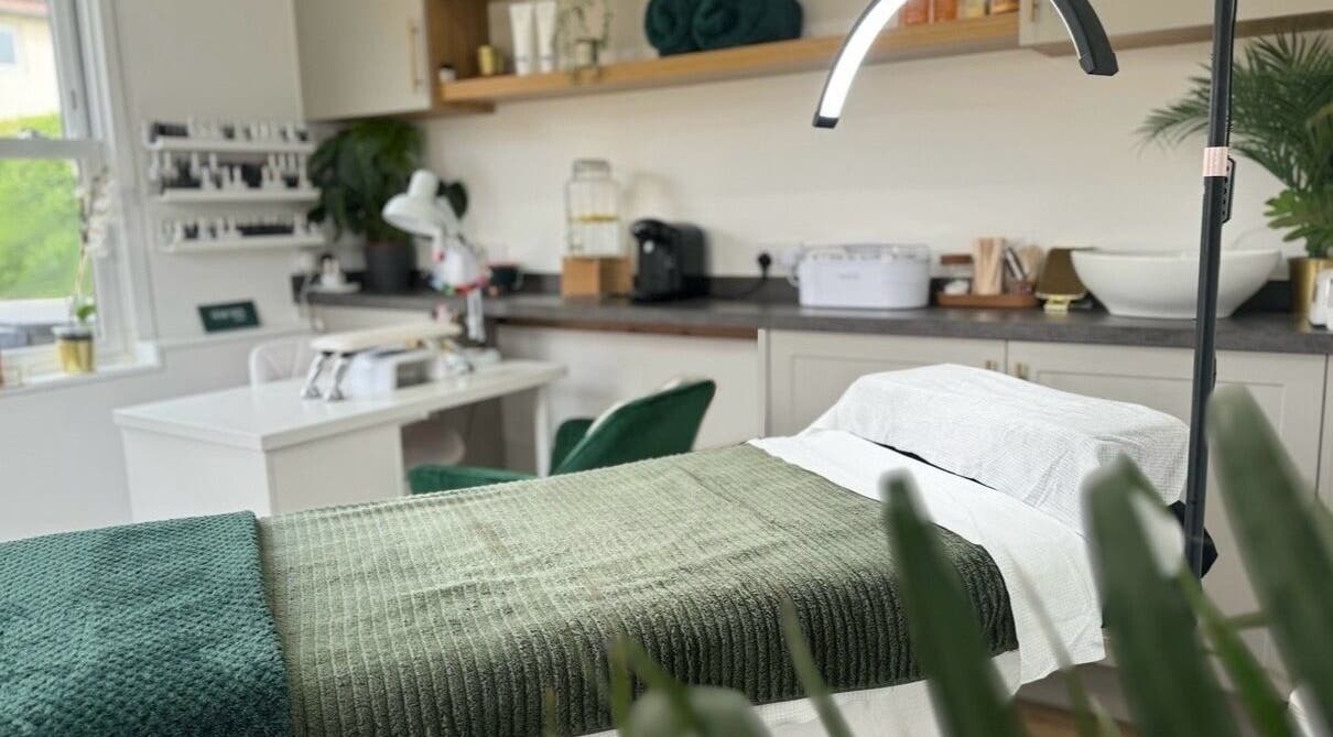 Luxurious treatment room at The Serenity Salon, Fareham, England, GB, featuring a cozy, green-themed decor.