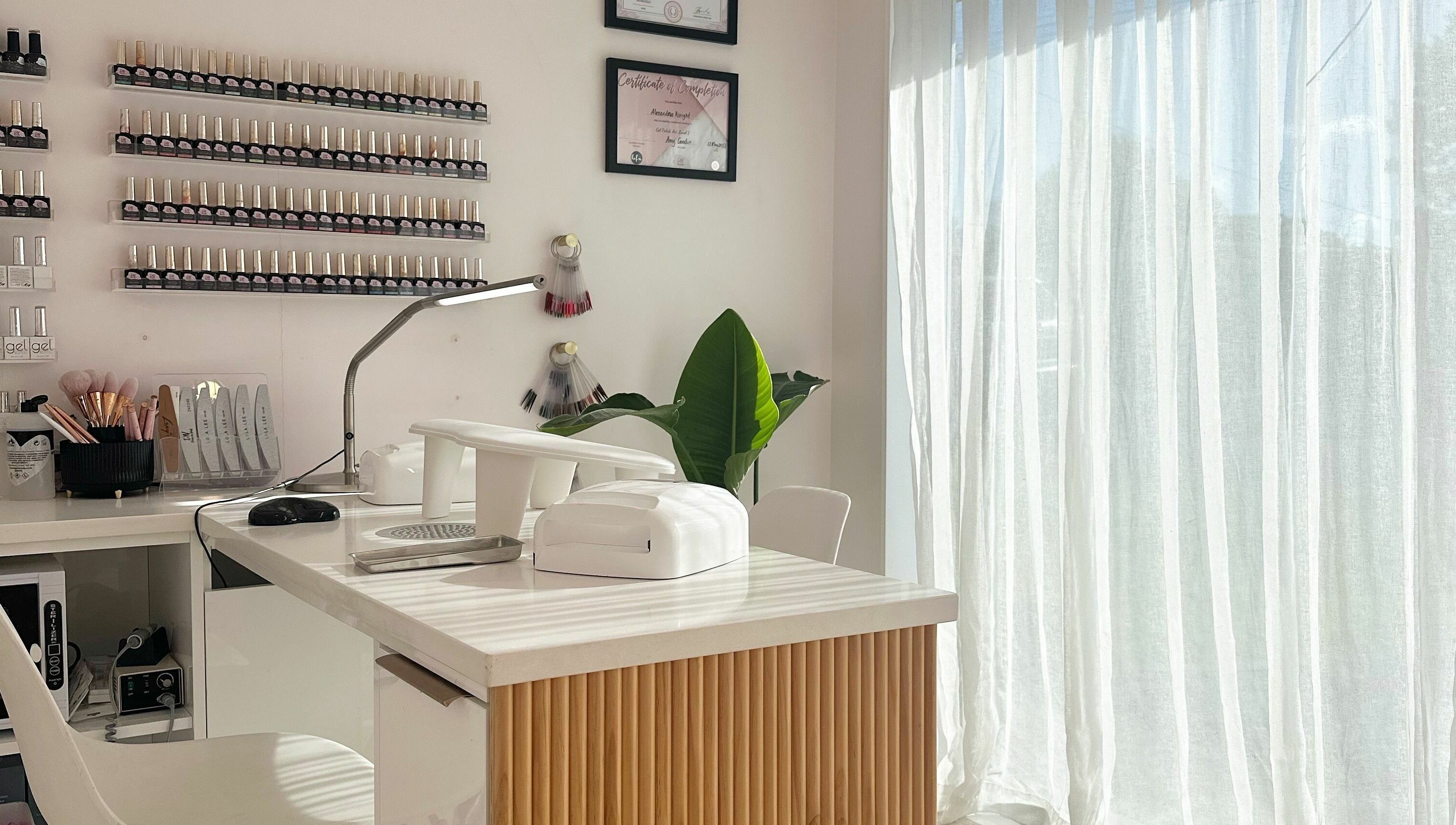 Sleek nail station at Nail Alley in Waipu, Northland, NZ with polish display and tools.