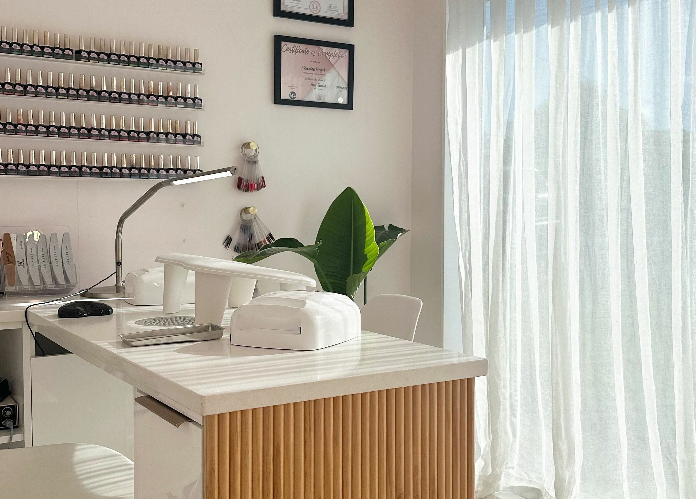 Sleek nail station at Nail Alley in Waipu, Northland, NZ with polish display and tools.