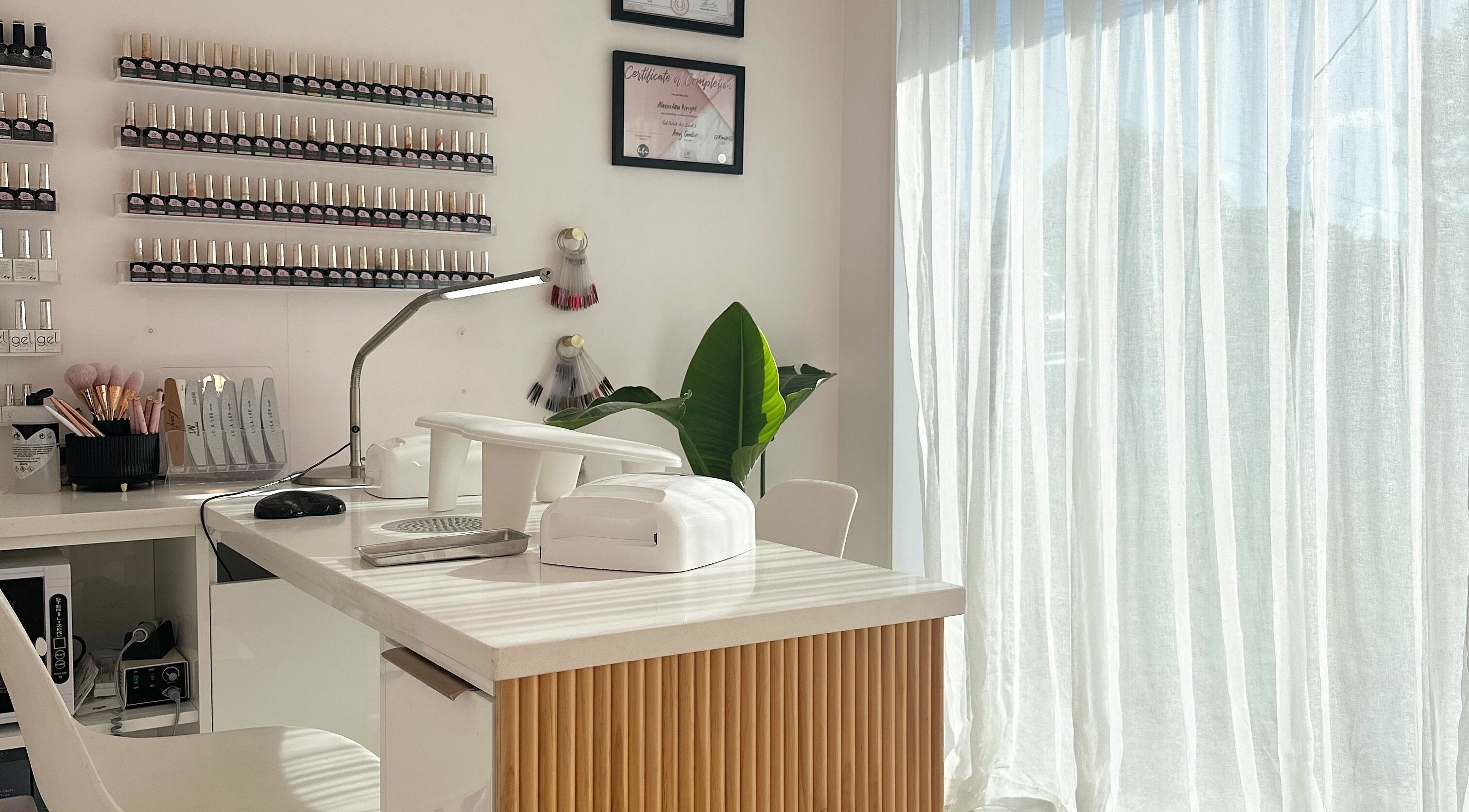 Sleek nail station at Nail Alley in Waipu, Northland, NZ with polish display and tools.