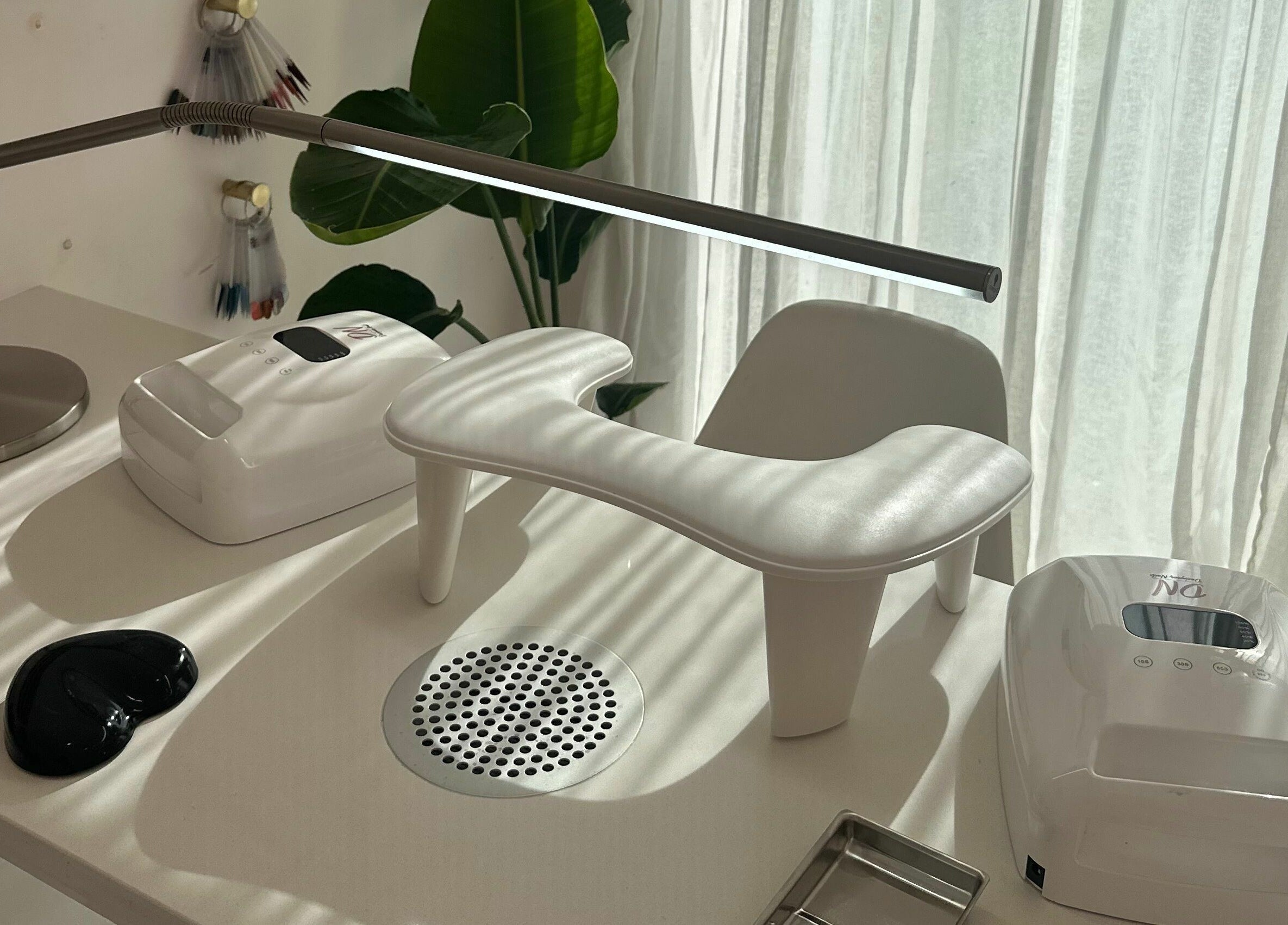 Elegant manicure station at Nail Alley, Waipu, Northland, NZ, bathed in sunlight with modern equipment.