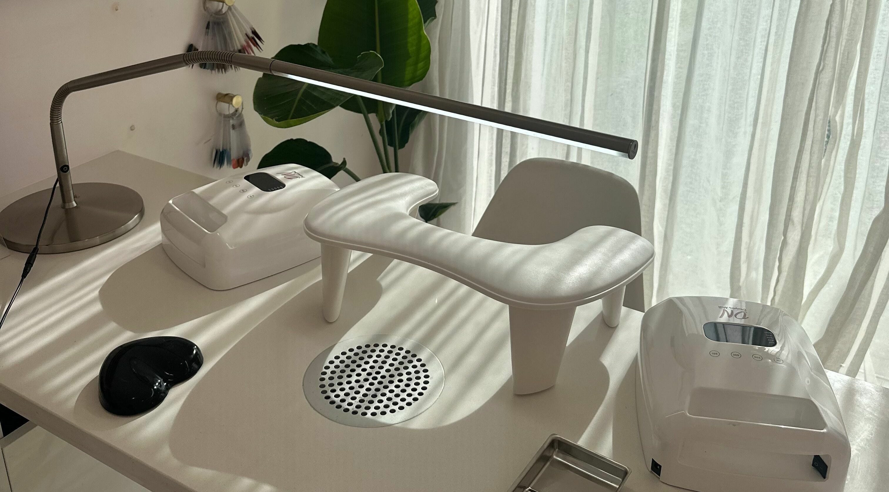 Elegant manicure station at Nail Alley, Waipu, Northland, NZ, bathed in sunlight with modern equipment.