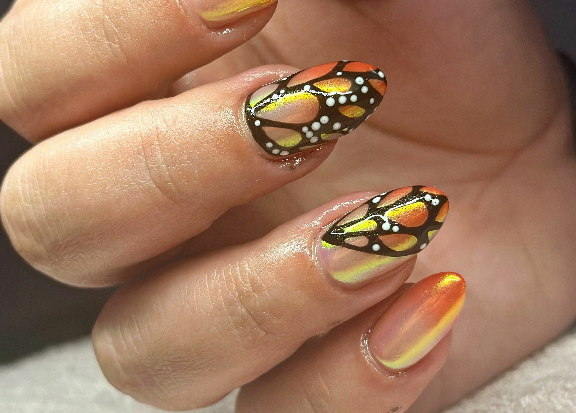 Intricate butterfly nail art at Nail Alley, Waipu, Northland, NZ. Orange, black, and white detail shines beautifully.