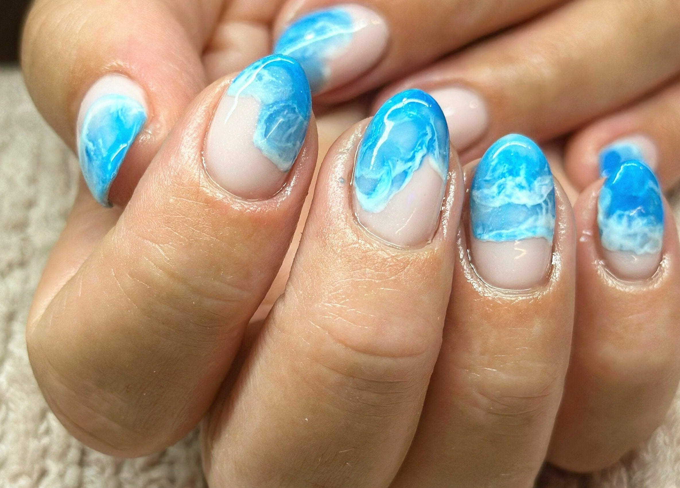 Close-up of blue ocean-themed nail art at Nail Alley, Waipu, Northland, NZ.