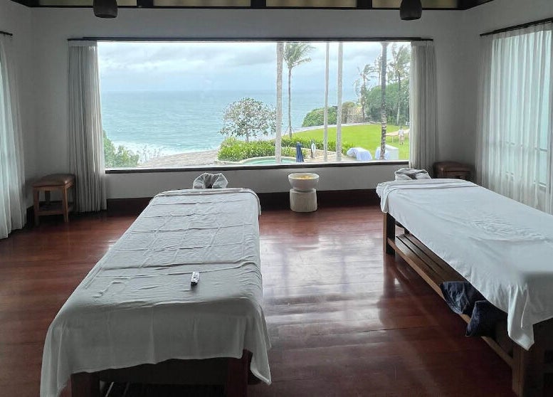 Relaxing massage room with ocean view at Vela Spa, Bali, Bali, ID, perfect for tranquility and rejuvenation.