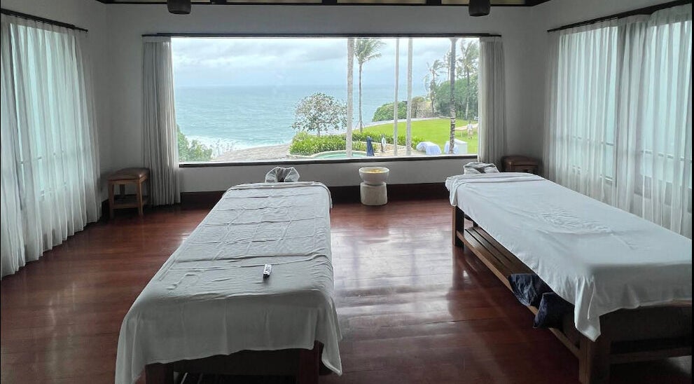 Relaxing massage room with ocean view at Vela Spa, Bali, Bali, ID, perfect for tranquility and rejuvenation.