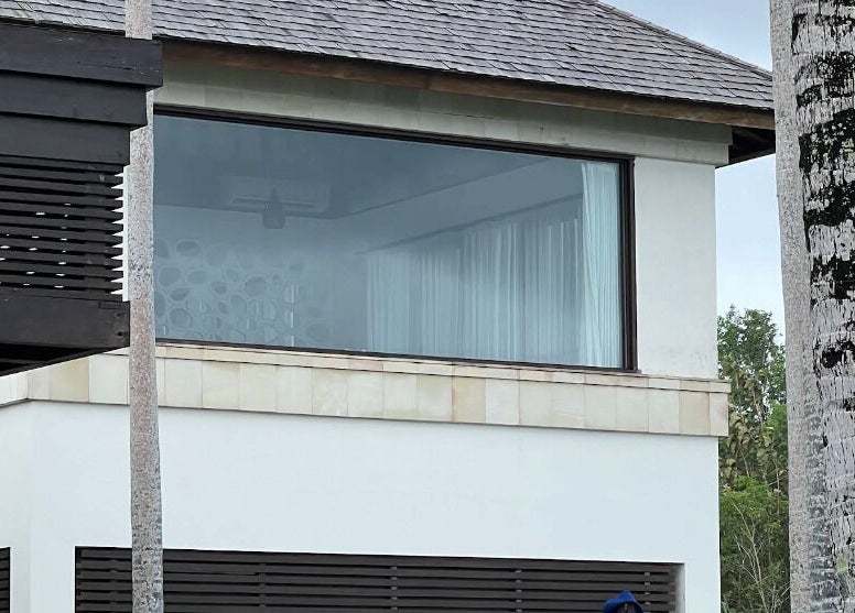 Modern exterior of Vela Spa in Bali, Bali, ID with large windows and lush surroundings.