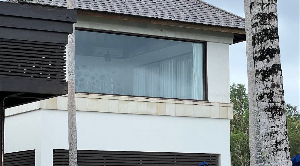 Modern exterior of Vela Spa in Bali, Bali, ID with large windows and lush surroundings.