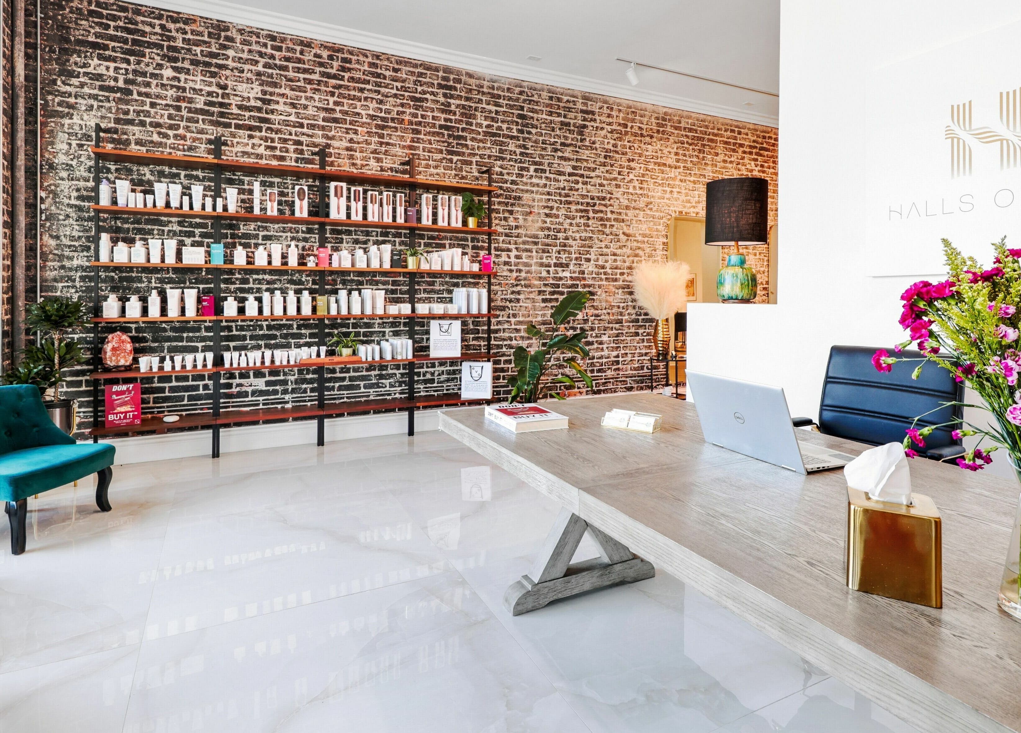 Interior of Halls Of Ivy Salon in Los Angeles, California, US with elegant decor and product shelves.