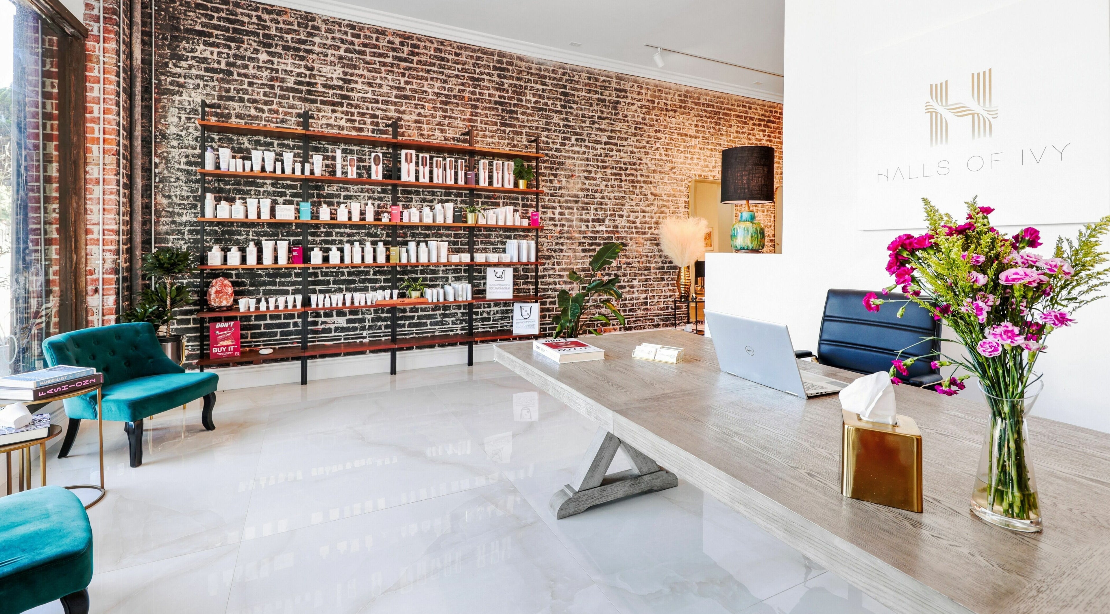 Interior of Halls Of Ivy Salon in Los Angeles, California, US with elegant decor and product shelves.