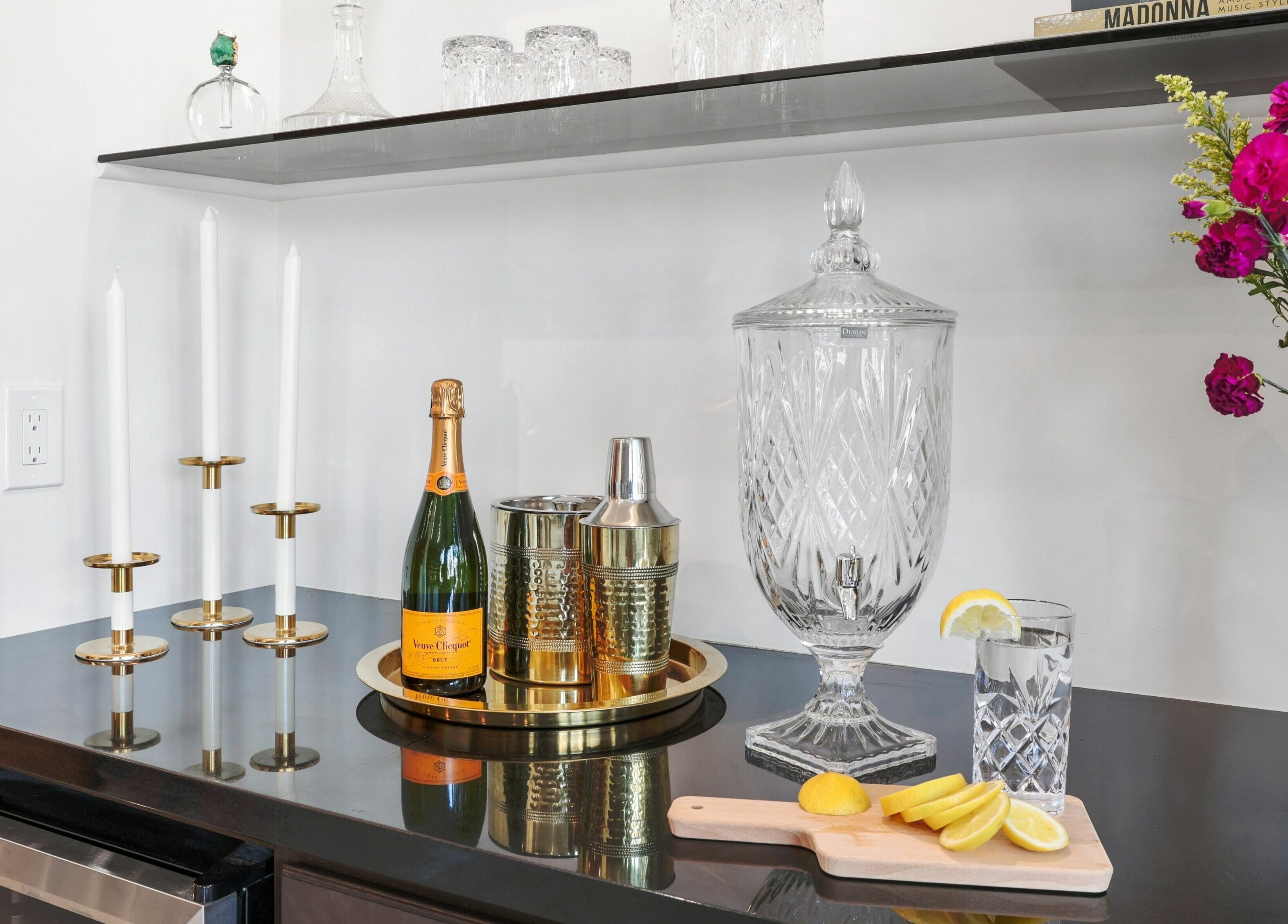 Elegant refreshment station at Halls Of Ivy Salon, Los Angeles, California, US with champagne and flowers.