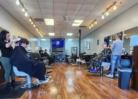 Stylish interior of Blackbeard Barbering Company P.A in Fernandina Beach, Florida, US, featuring skilled barbers at work.