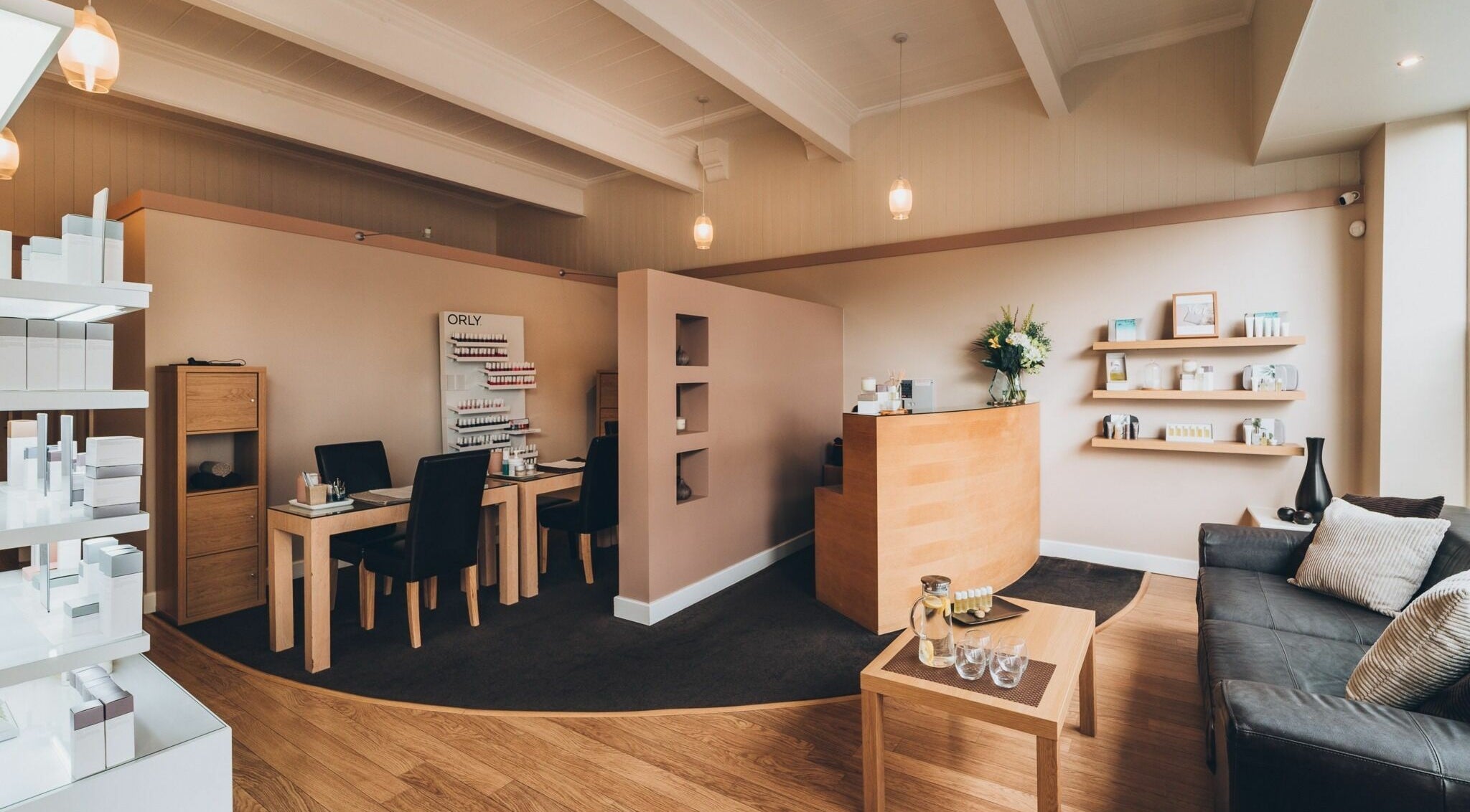 Elegant interior of Chill Beauty, Wakefield, England, GB with cozy seating, wooden decor, and beauty products.