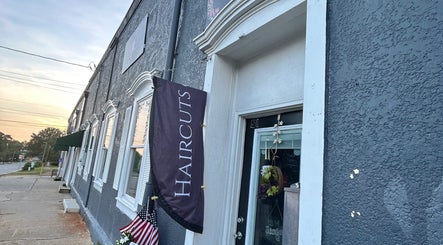 Entrance of More Good Hair Days Salon in Forsyth, Georgia, US with a chic exterior and flag sign.