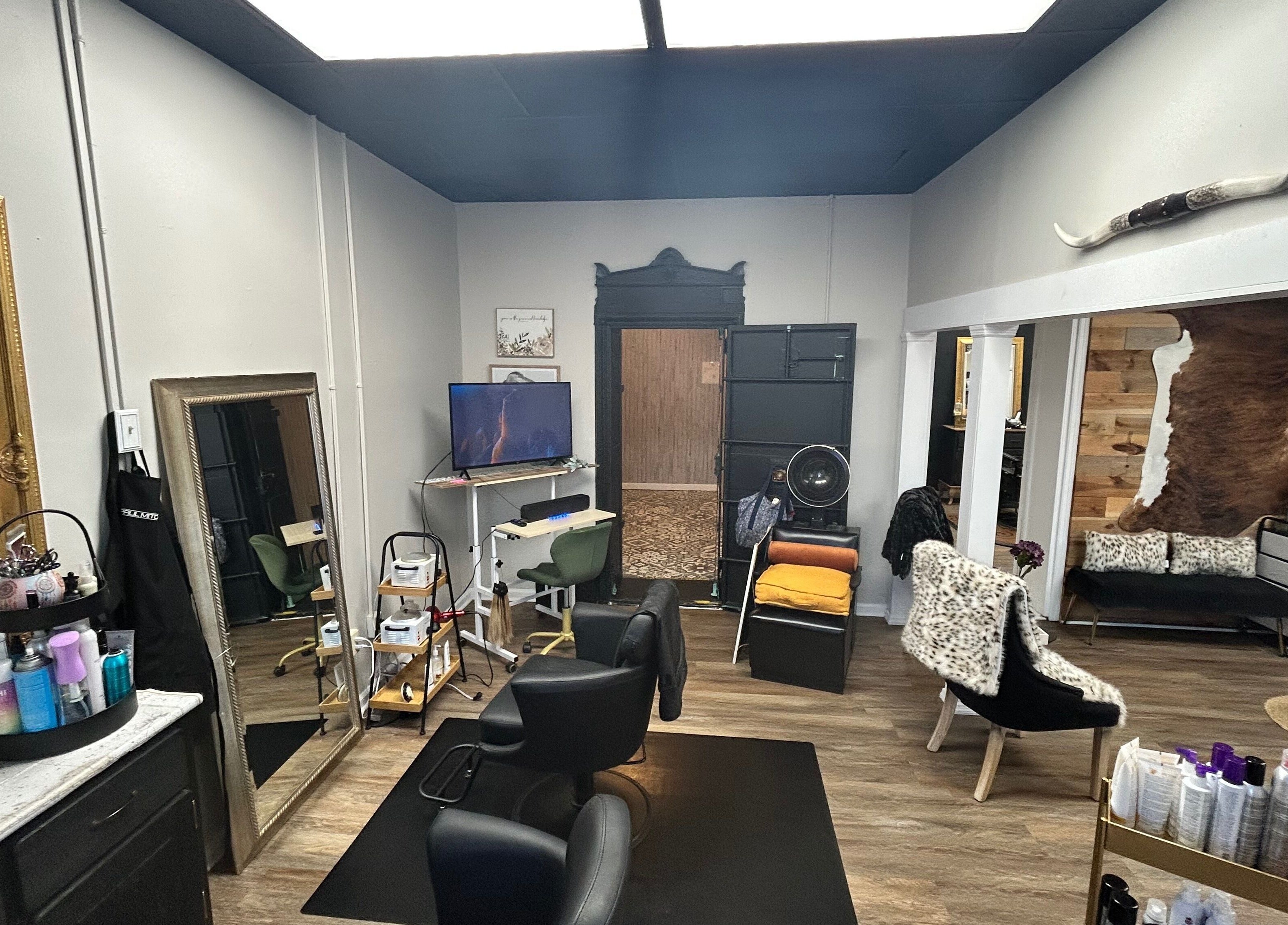 Modern salon interior of More Good Hair Days Salon in Forsyth, Georgia, US with stylish seating and mirrors.