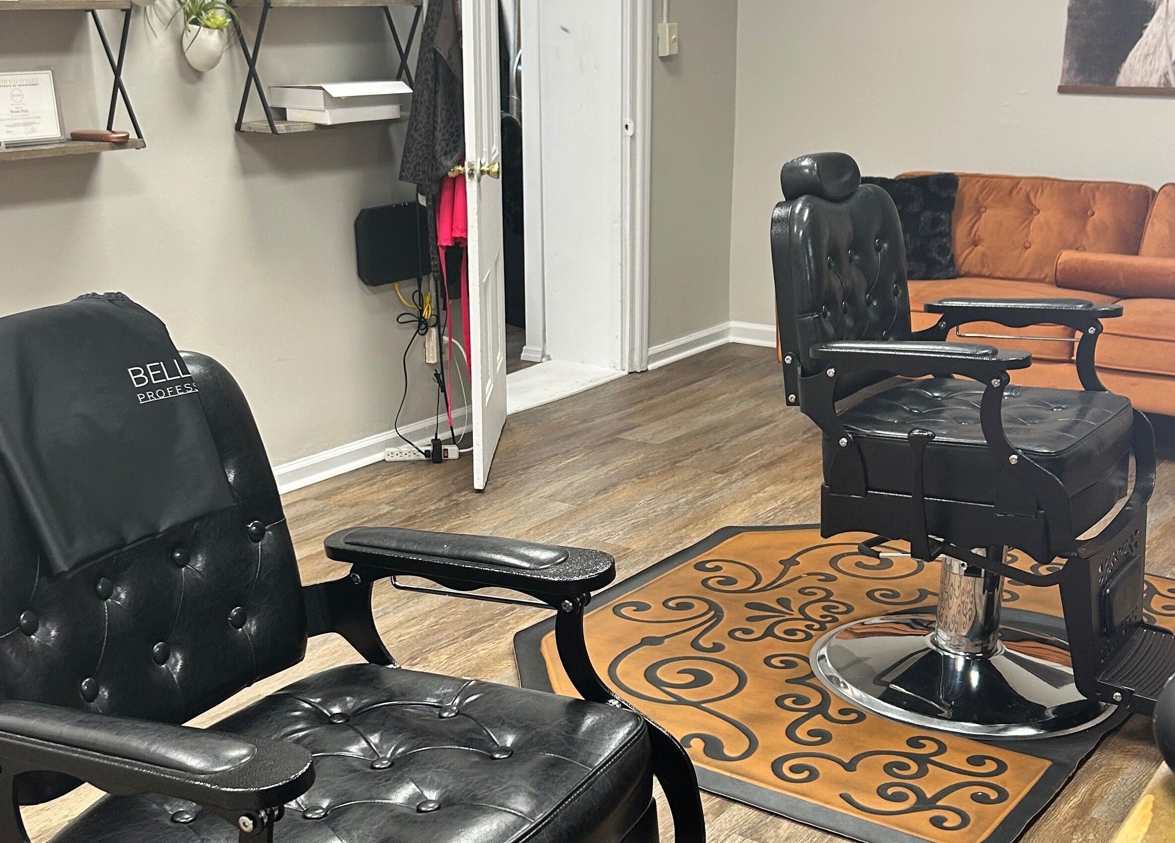 Chic interior of More Good Hair Days Salon in Forsyth, Georgia, featuring elegant black chairs and cozy seating.