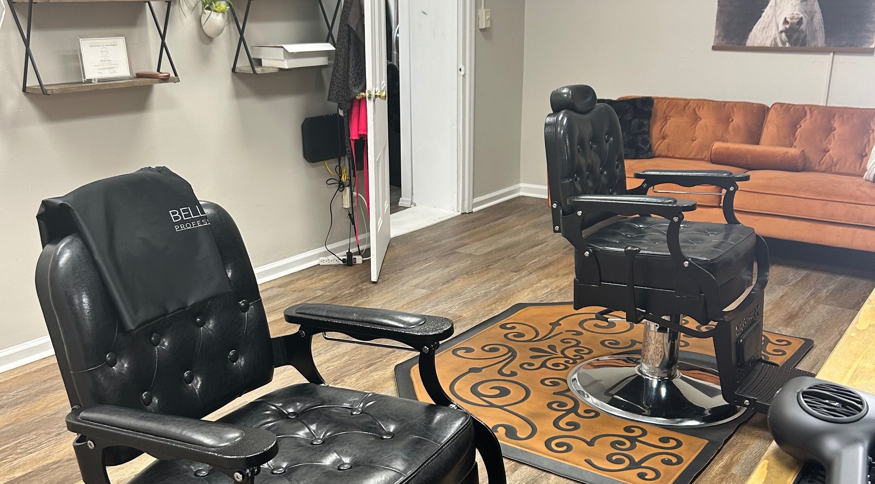 Chic interior of More Good Hair Days Salon in Forsyth, Georgia, featuring elegant black chairs and cozy seating.