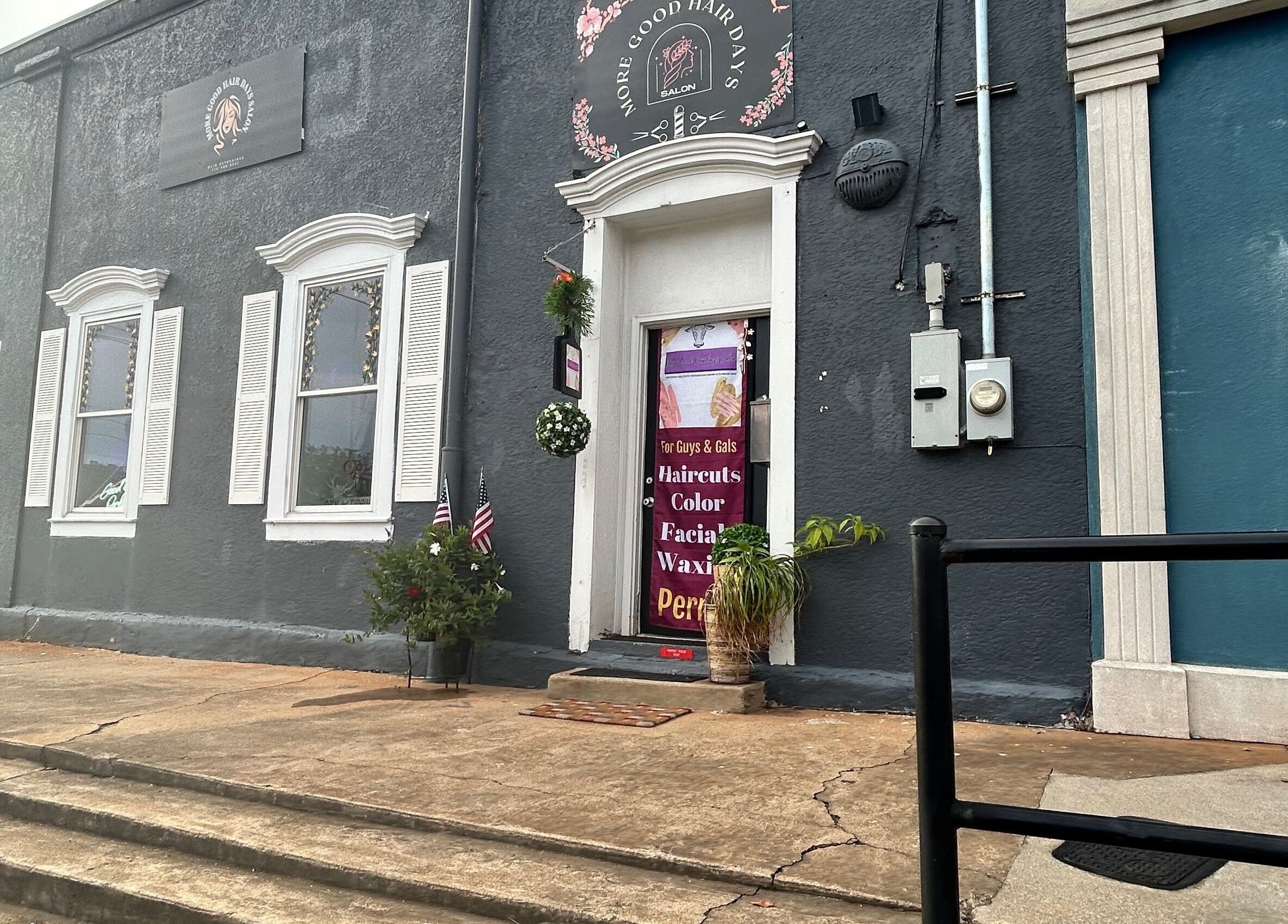 Front entrance of More Good Hair Days Salon in Forsyth, Georgia, showcasing service offerings on the door.