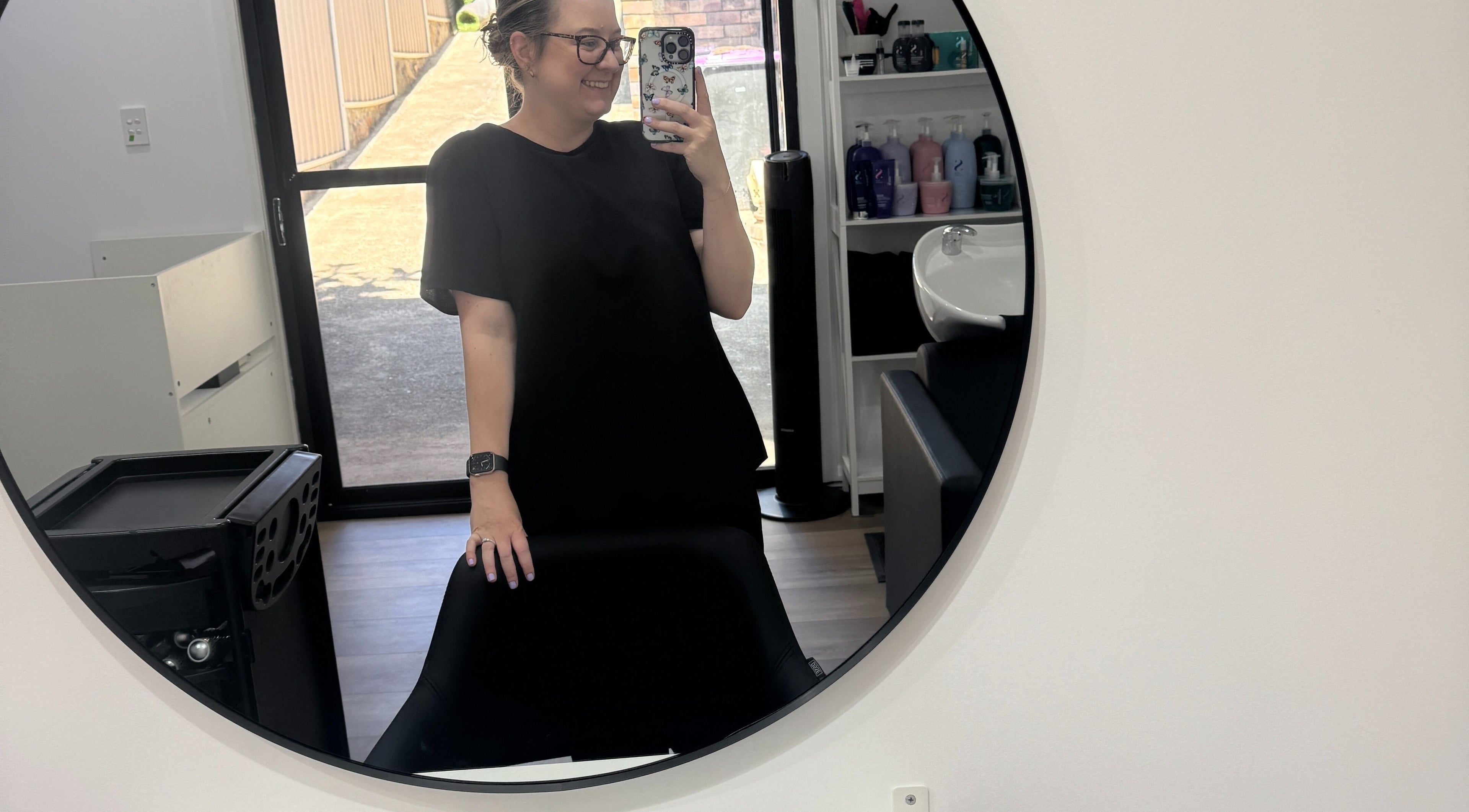 Inside HairEm Creations salon in Kirrawee, New South Wales, AU, showcasing a stylish mirror and salon equipment.