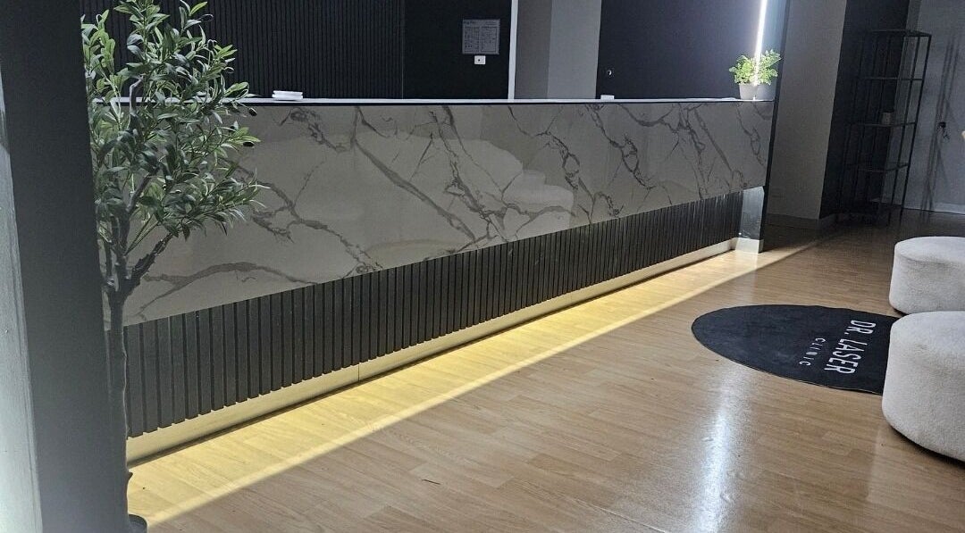 Sophisticated reception area at Dr.Laser Clinic, Melbourne, Victoria, AU with marble and plants.
