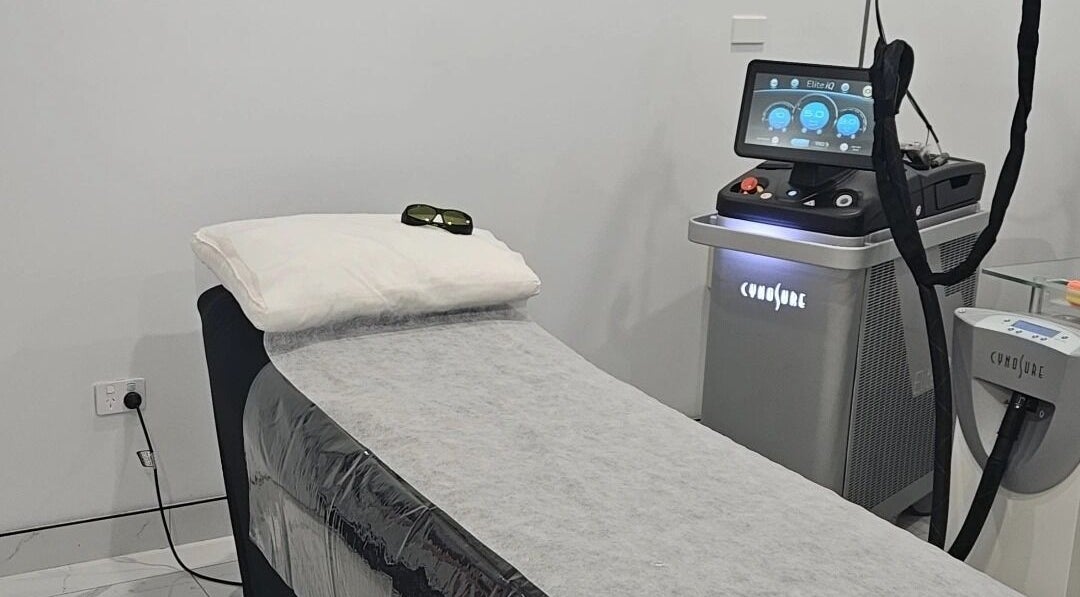 Modern laser treatment room at Dr.Laser Clinic, Melbourne, Victoria, AU, featuring advanced equipment and bed.