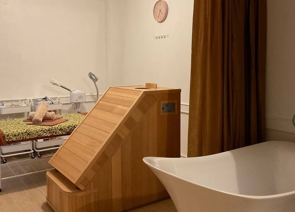 Relaxing spa room at LAWA LAWA SPA @Menara Zurich, Johor Bahru, featuring massage table and modern shower.