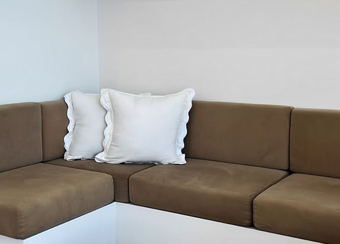 Comfortable seating area at Séjour Spa and Nails, Eastgardens, New South Wales, AU, with plush cushions.