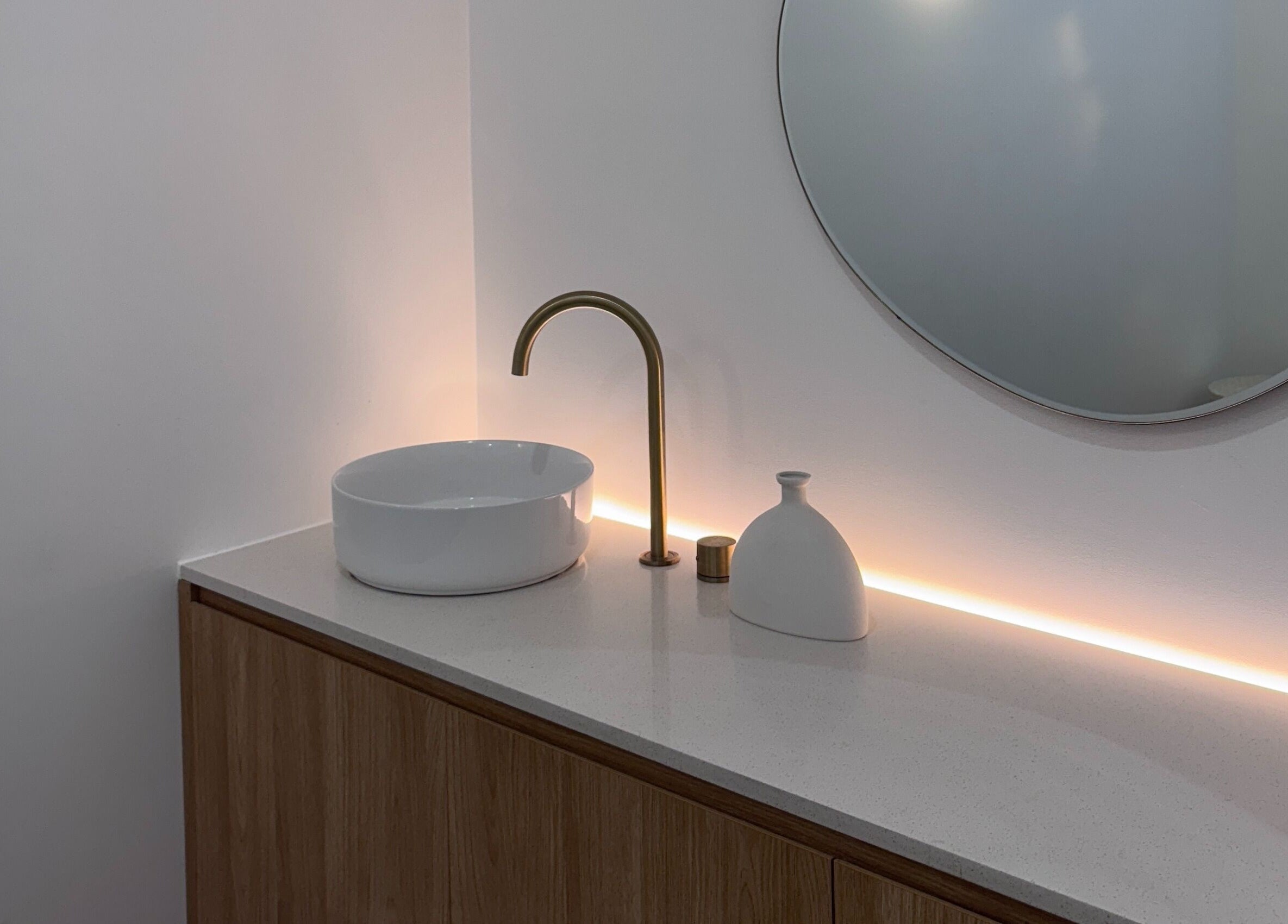 Elegant vanity with gold faucet and round mirror at Séjour Spa and Nails, Eastgardens, New South Wales, AU.