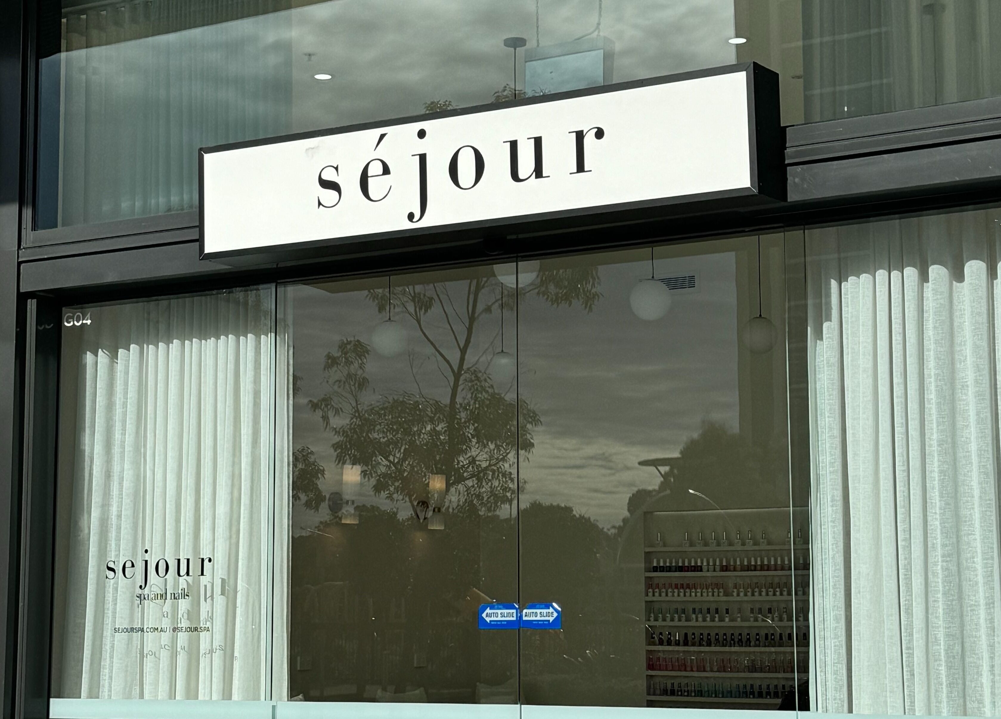 Entrance of Séjour Spa and Nails, Eastgardens, New South Wales, AU with elegant glass and signage.