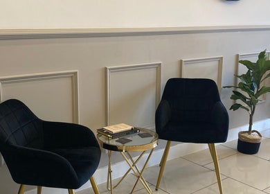 Elegant seating area with black chairs and plant at Lucy Angel, Lowestoft, GB.