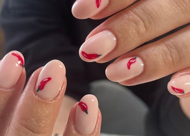 Elegant chili-themed nail art at Polish Me Pretty in Walkern, England, GB. Perfect for a bold, unique look.