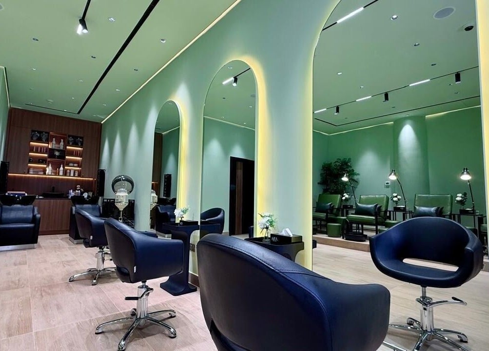 Chic interior of AZUL BEAUTY SALON-L.L.C, Abu Dhabi, AE with sleek chairs and stylish green accents.