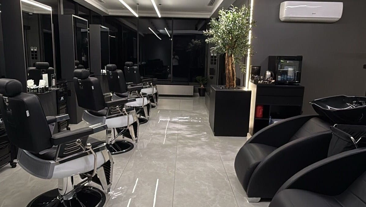 Luxurious barber interior at Barber, Amman, Amman Governorate, JO with sleek chairs and elegant decor.