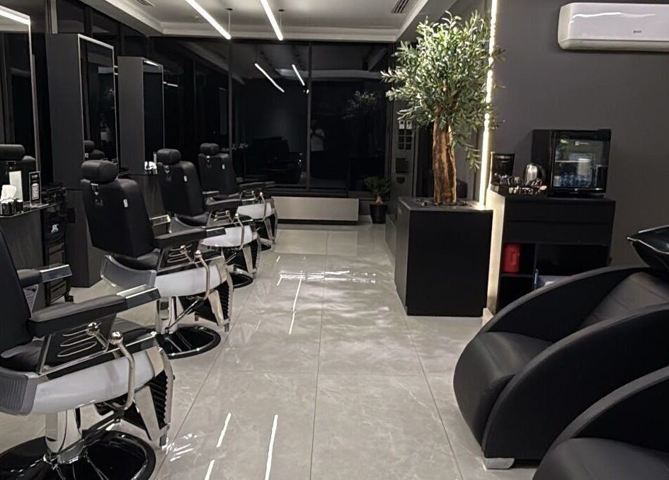 Luxurious barber interior at Barber, Amman, Amman Governorate, JO with sleek chairs and elegant decor.
