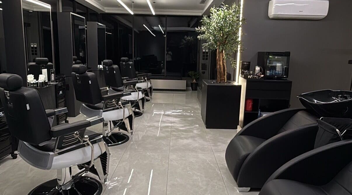 Luxurious barber interior at Barber, Amman, Amman Governorate, JO with sleek chairs and elegant decor.