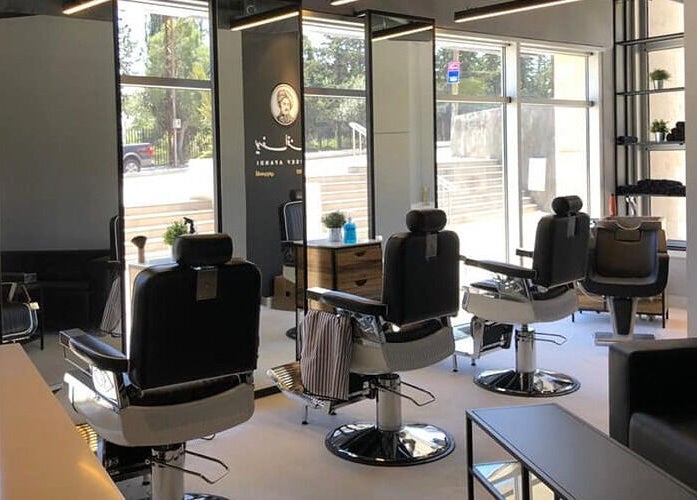 Chic interior of Yousef Afandi- Rabieh salon in Amman, Amman Governorate, JO with sleek barbershop chairs.