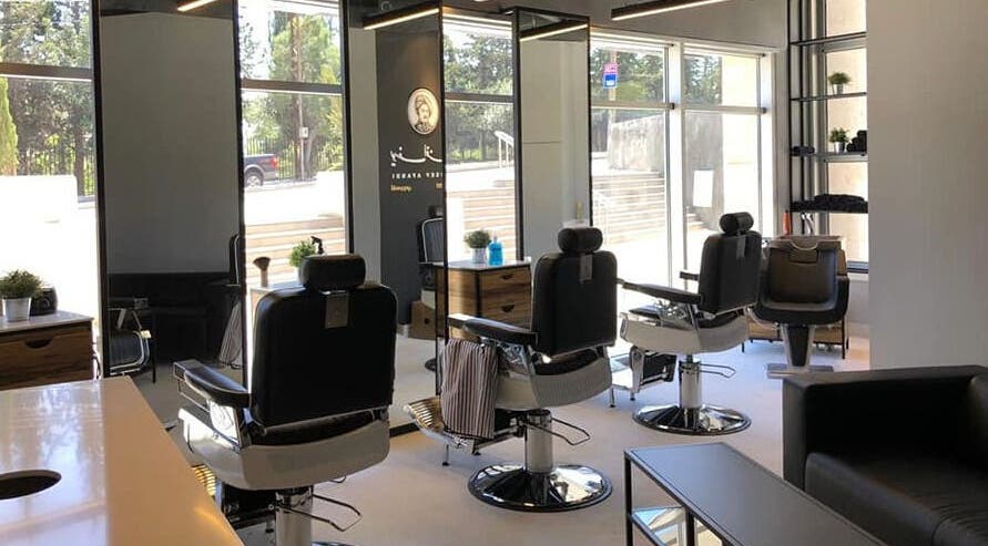 Chic interior of Yousef Afandi- Rabieh salon in Amman, Amman Governorate, JO with sleek barbershop chairs.