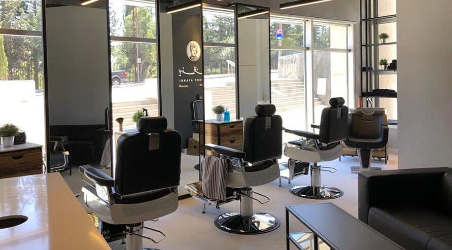 Chic interior of Yousef Afandi- Rabieh salon in Amman, Amman Governorate, JO with sleek barbershop chairs.