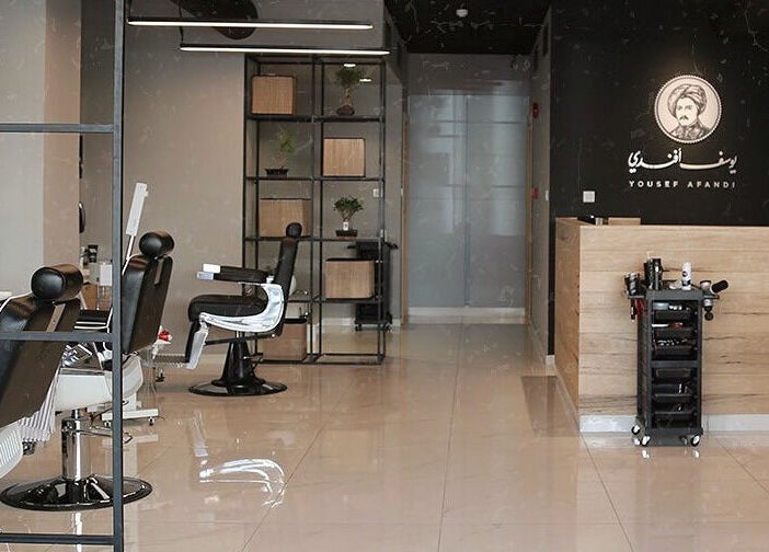 Modern salon interior at Yousef Afandi- Rabieh in Amman, Amman Governorate, JO with stylish black chairs.