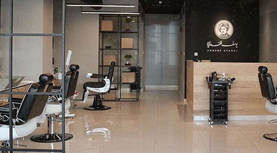 Modern salon interior at Yousef Afandi- Rabieh in Amman, Amman Governorate, JO with stylish black chairs.