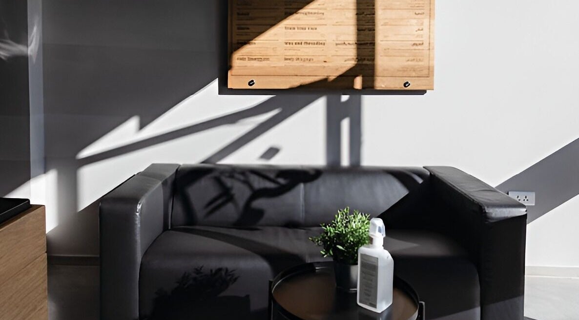 Modern lounge area at Yousef Afandi- Rabieh, Amman, Amman Governorate, JO with black sofa and decor.