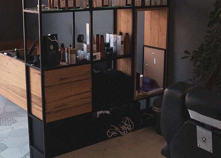 Yousef Afandi- Rabieh salon interior in Amman, Amman Governorate, JO featuring sleek shelves and seating.