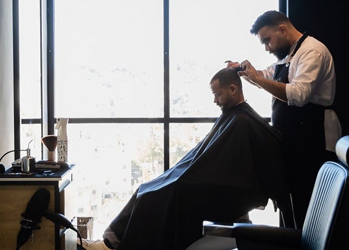 Barber at Yousef Afandi- Rabieh giving a haircut in Amman, Amman Governorate, JO with a scenic view.
