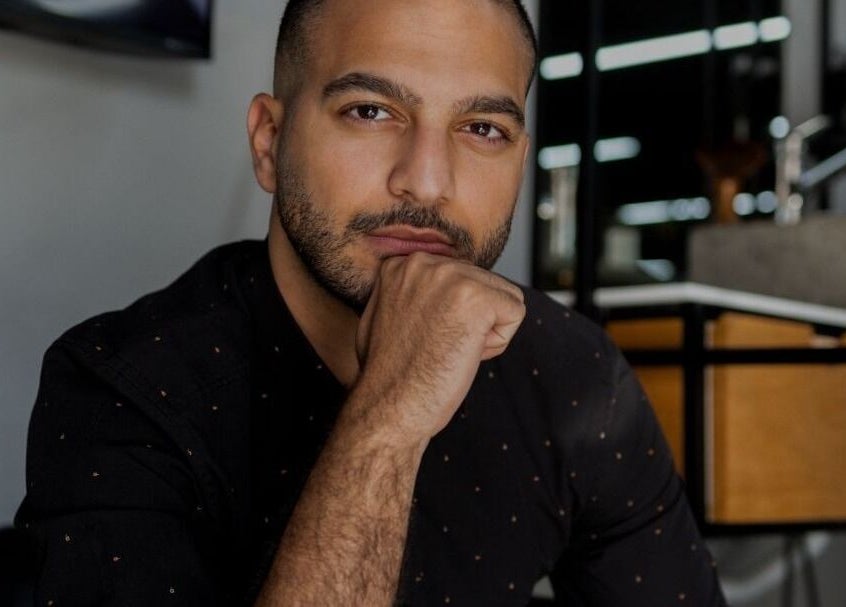 Man at Yousef Afandi Express- Um Zwaitina, Amman radiating confidence in modern setting.