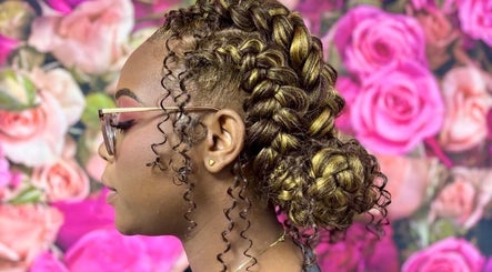 Intricate braids styled at Beauty Hub, located in George Town, Grand Cayman, KY, against a floral backdrop.