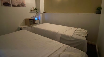 Tranquil massage room at Organic Thai Massage, Spa and Facial, Torrance, California, US with two relaxing beds.