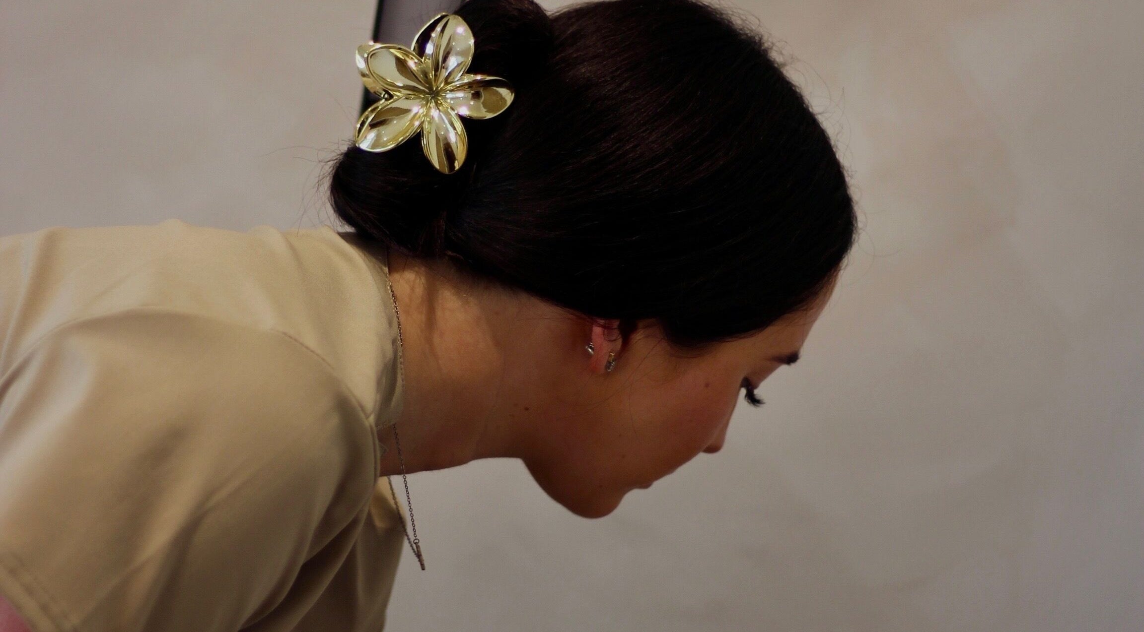 A close-up of a woman with a golden hairpiece at Enhanced by Els, Worthing, England, GB.