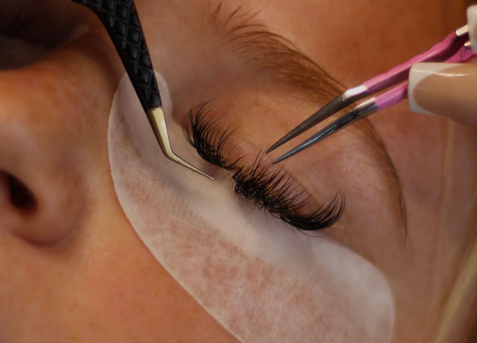Close-up of eyelash extensions being applied at Enhanced by Els, Worthing, England, GB.